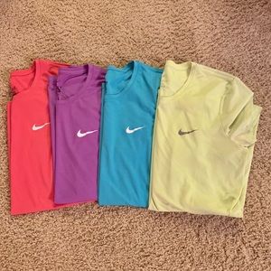 A set of 4 Nike Dri-Fit Shirts in Various Colors